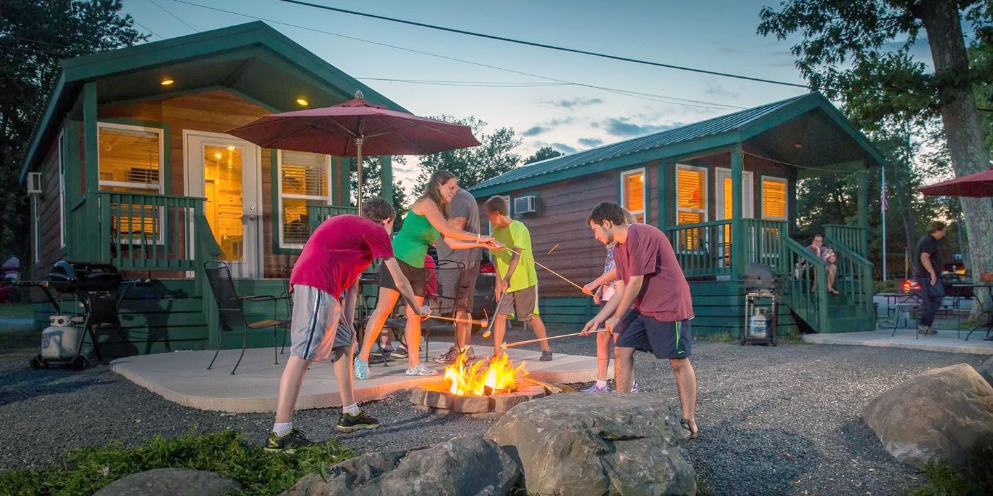 Myrtle Beach KOA Resort: Why You Should Make It Your Next Vacation Spot 1 People playing around a campfire at Myrtle Beach KOA Resort